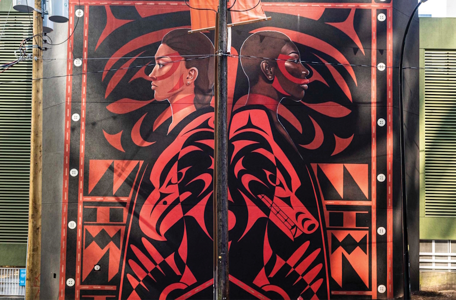 Mural of two people back to back in Vancouver, BC