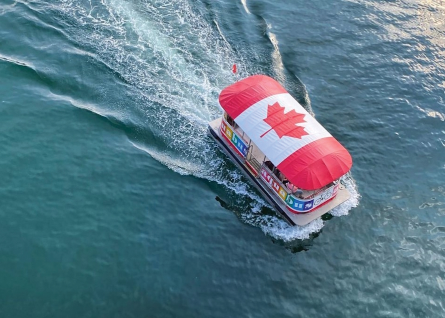 Aquabus with a large Canadian flag on the roof