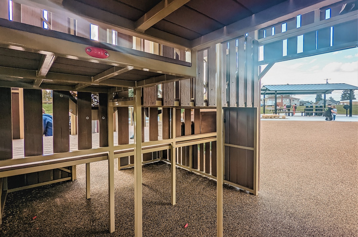 The lower level of the play barn at Edgewood Community Park includes a red apple symbol to find on the scavenger hunt