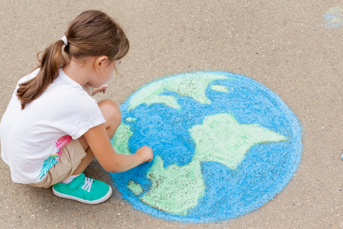 girl drawing earth on sidewalk with chalk kids become activists eco learning at home