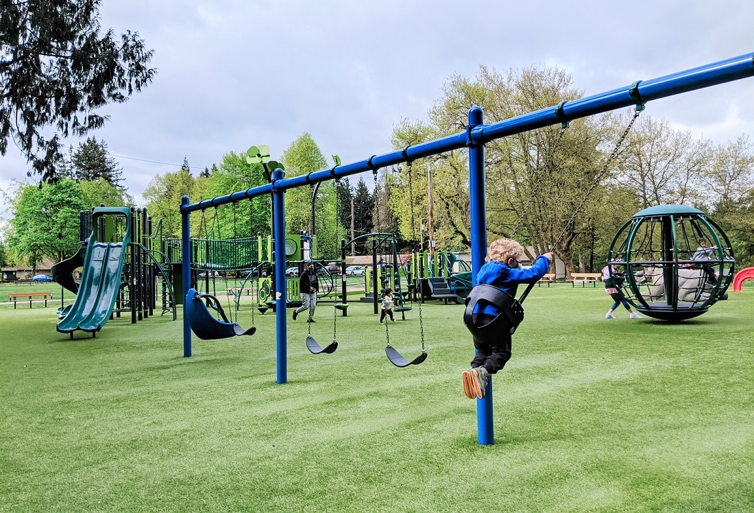 Swing set at new playground at Everett's Forest Park all abilities inclusive play space Everett Seattle Bellevue kids families