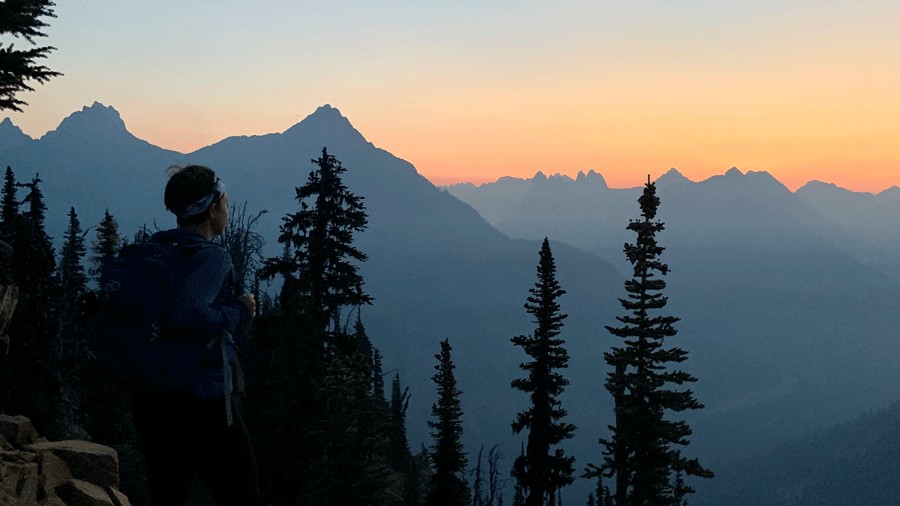 hiker on Maple Pass looking out over North Cascades National Park in Washington