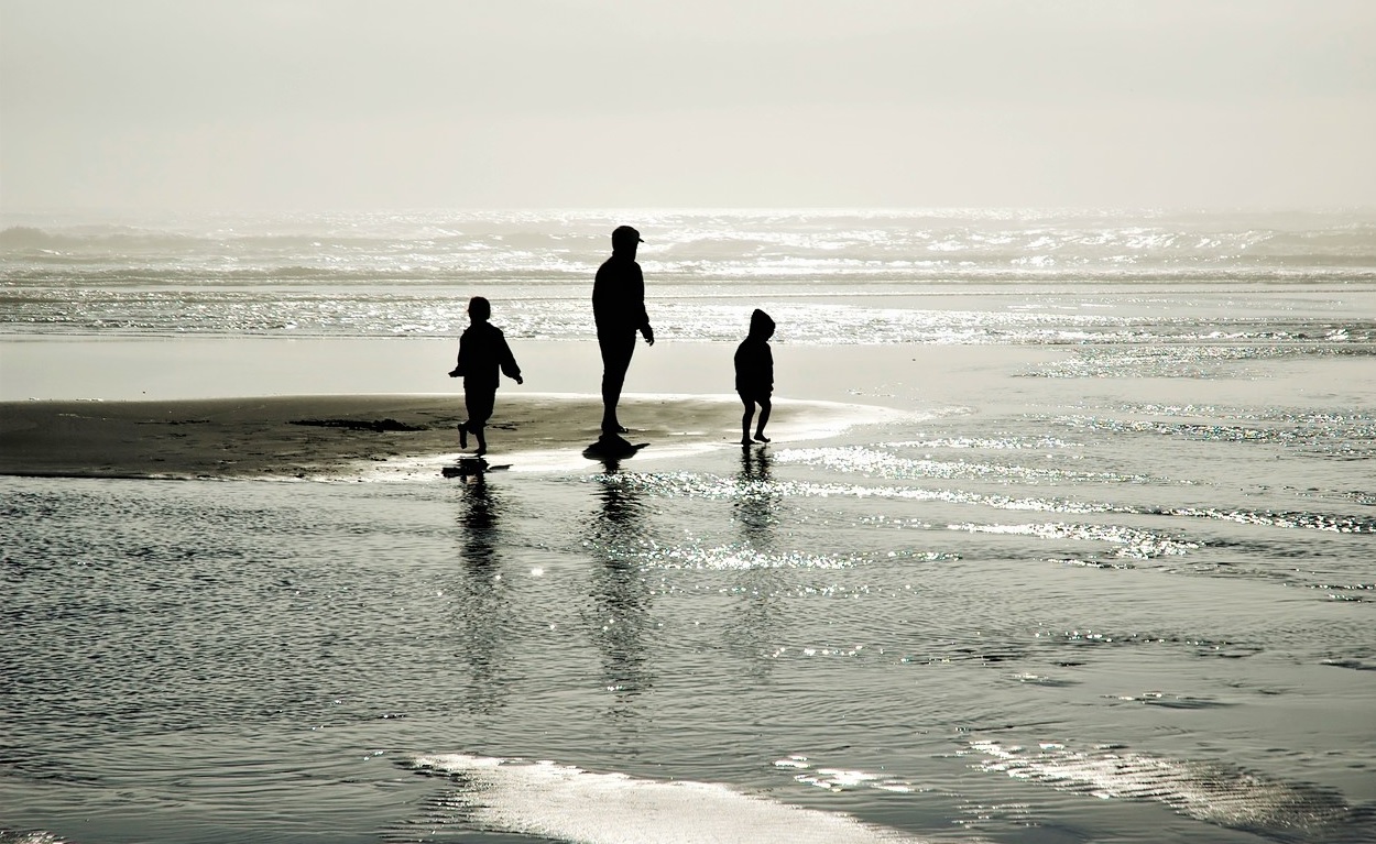 Kids playing in the small waves at Long Beach Washington best family getaways from seattle for winter spring 2021-2022
