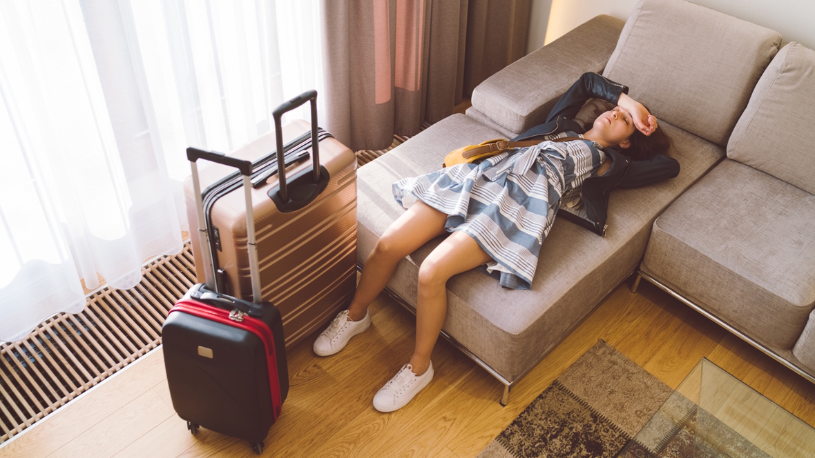 mom exhausted on a couch at the end of a family vacation