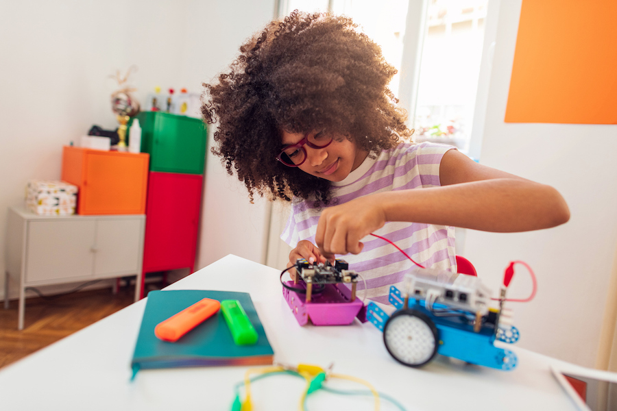 creative tween girl building a STEAM project