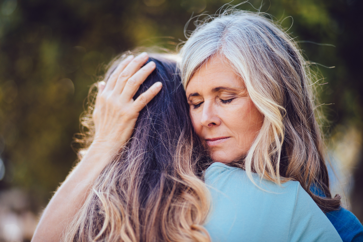 Mother-hugging-daughter-college-drop-off-saying-goodbye