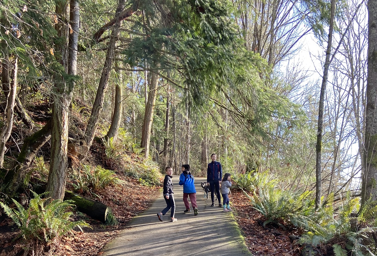 Group of kids hiking along a paved trail near Fort Ward on Bainbridge Island best hikes with kids