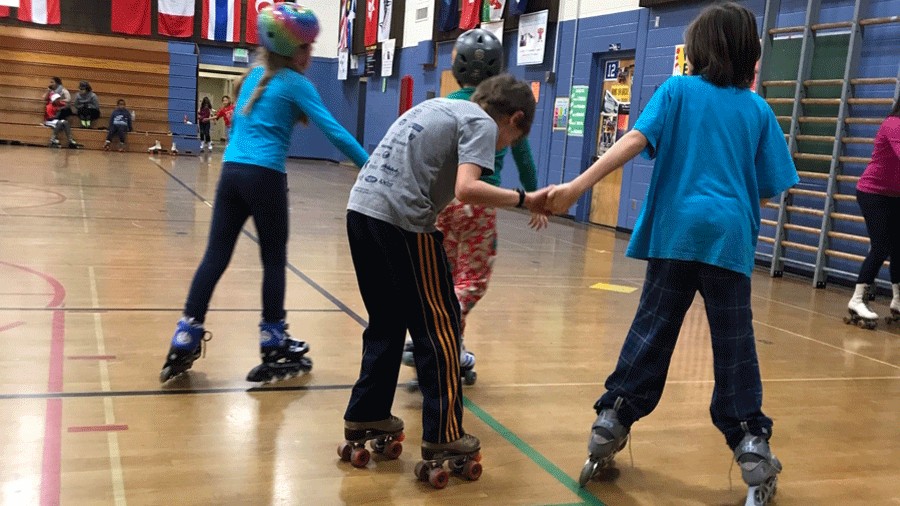 kids holding hands skating at bitter lake community center family skate night