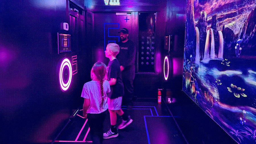 kids selecting games outside the arcade room at C.H.E Arcade