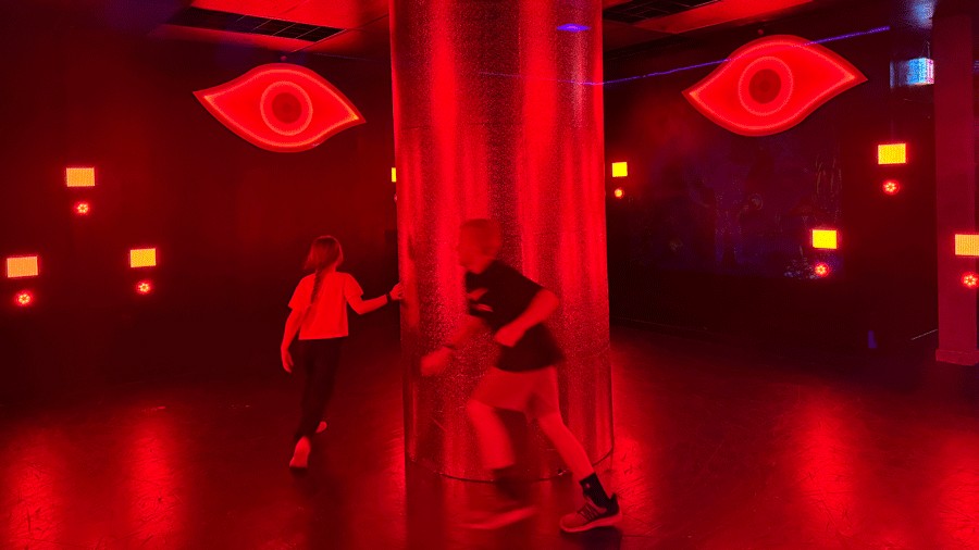 Room 2 at C.H.E Arcade with a bright red eye watching kids play