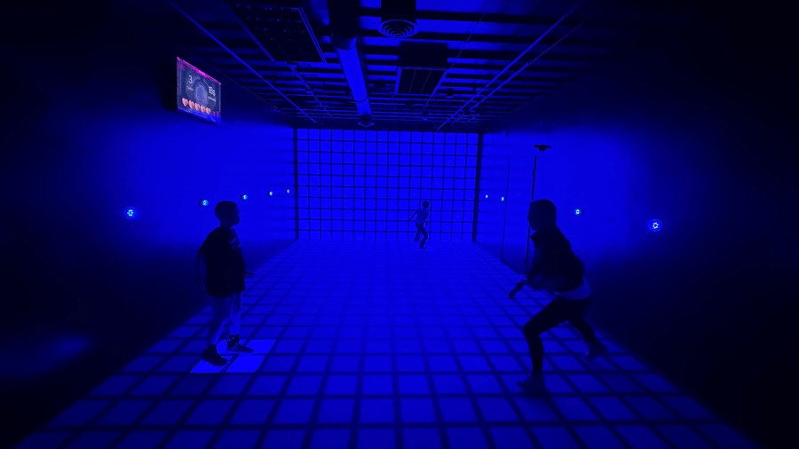 pixel room at C.H.E Arcade with bright lights and challenges for families to compete