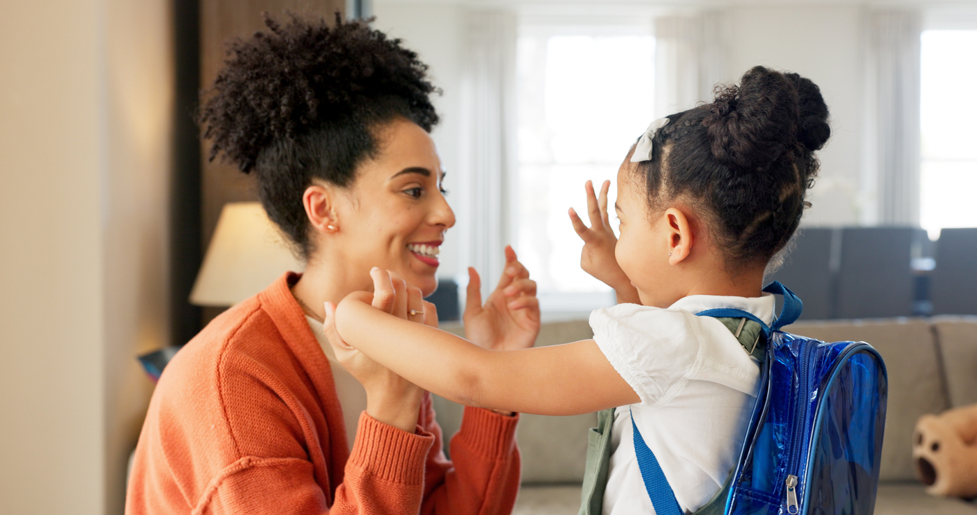 mom and child say goodbye as the child goes back to school