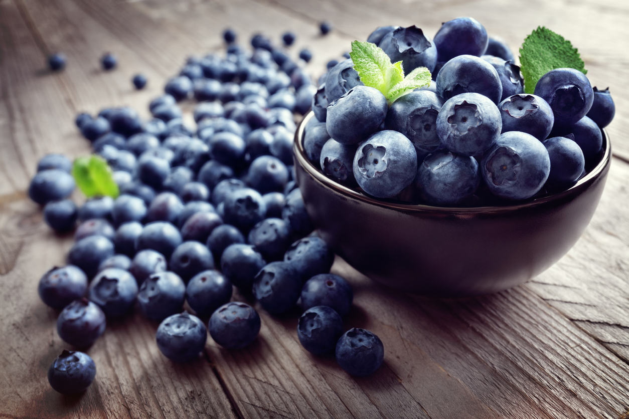 Blueberries on a bowl and on a table