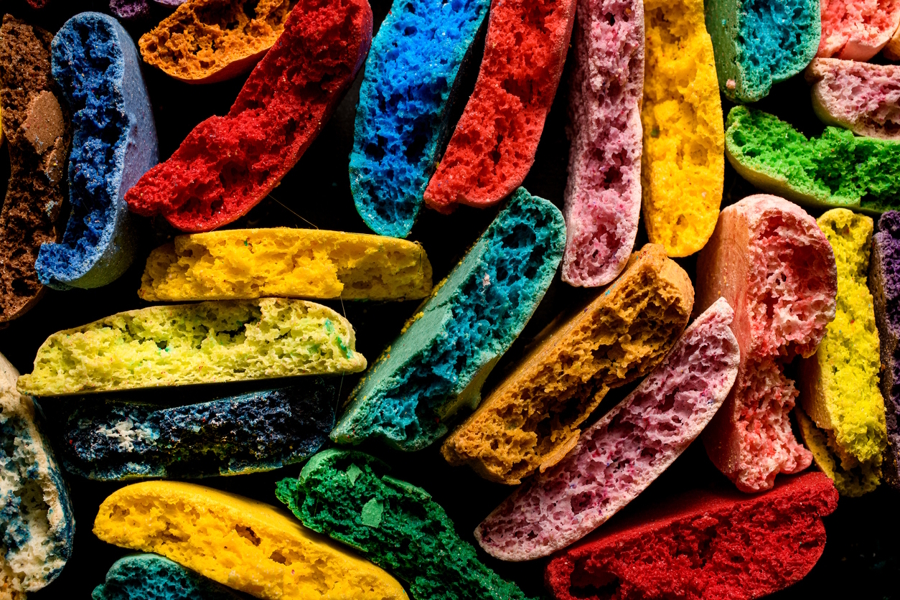 a pile of cookies that are dyed bright colors