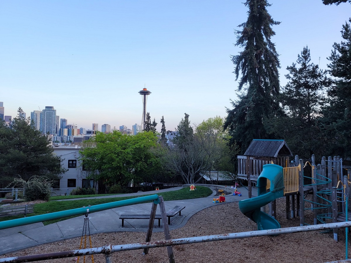 View of the Space Needle with the top painted orange from tiny Ward Springs Park on the south slope of Queen Anne Hill