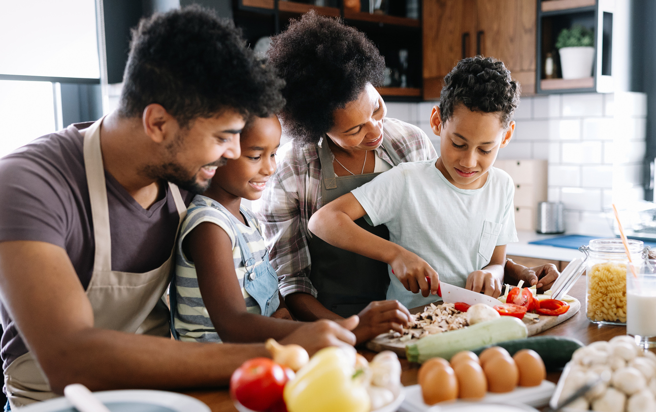 Happy family in the kitchen having fun and cooking together