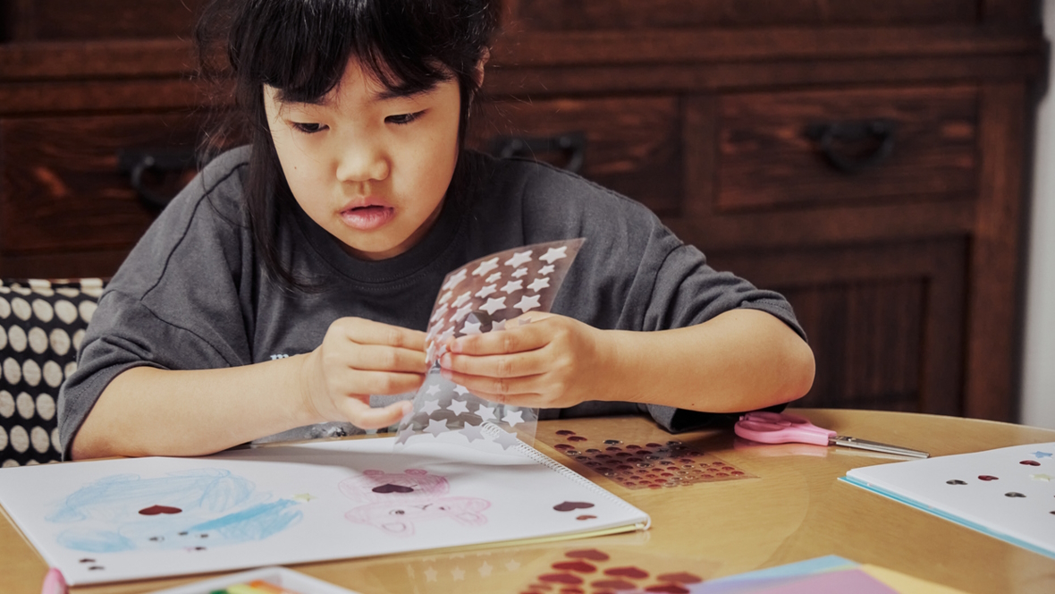 Girl making a valentine with stars on it