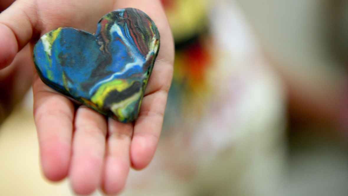 a crayon in the shape of a heart made from melted crayons