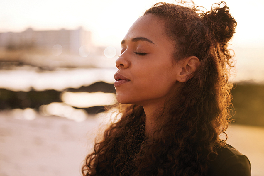 Woman with her eyes closed breathing in deeply