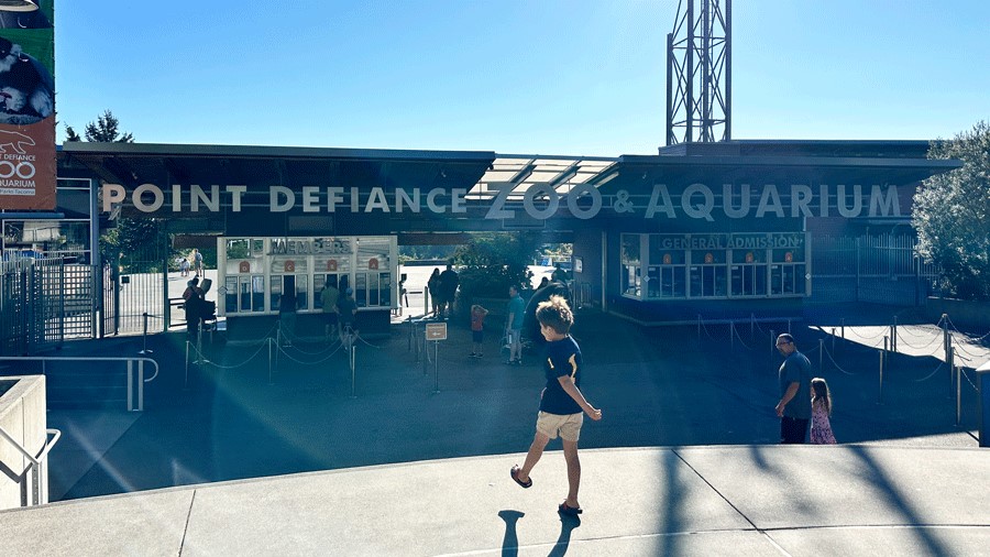 Young boy walking into the entrance of the Point Defiance Zoo & Aquarium