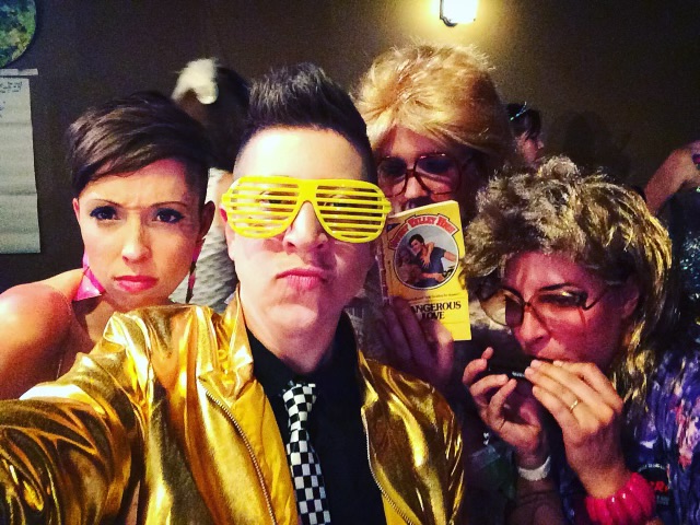 A group of festive middle age ladies take a curious selfie at Mom Prom.