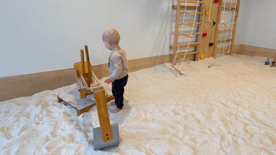 young boy exploring the sandbox at Wildflower Play Studio