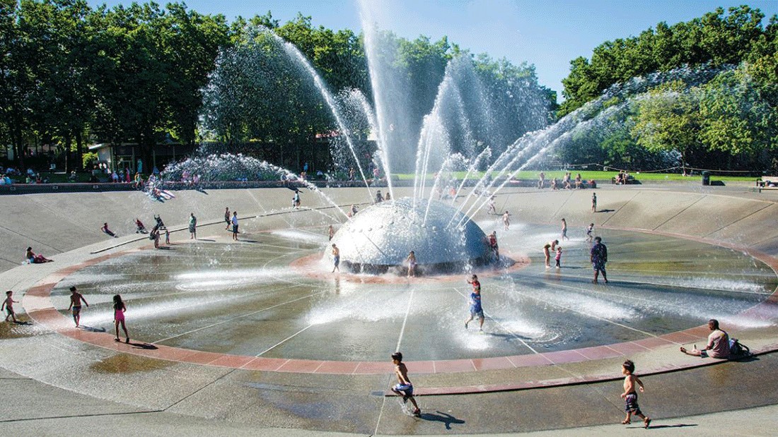 seattle center fountain spray park and splash pad with kids playing on a summer day