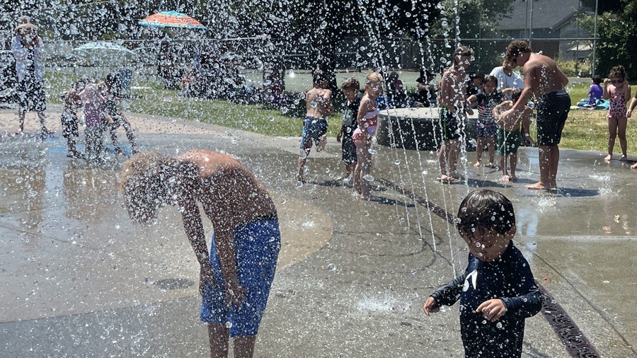 Kids splashing in a spray of water at highland park