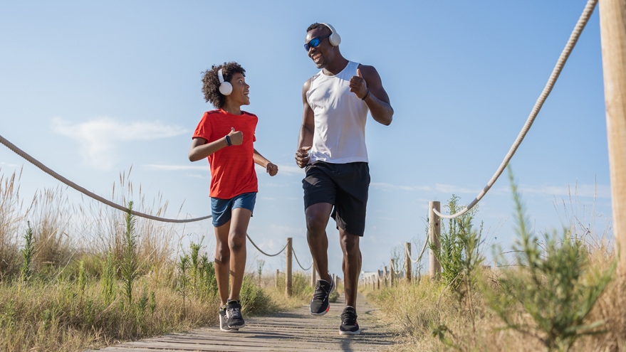 Dad and son happily running benefits of running for kids