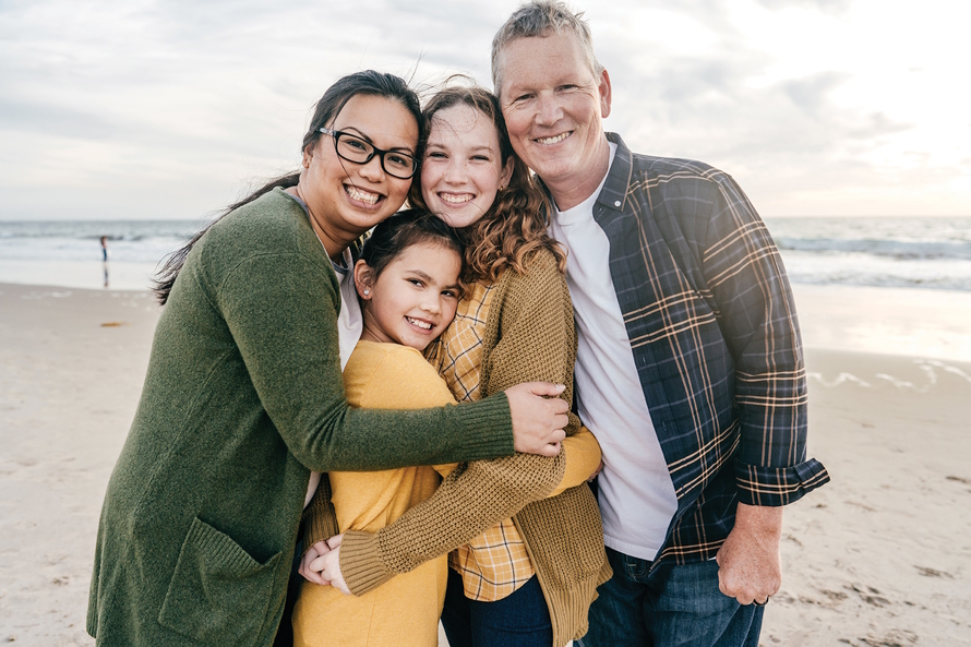 Family smiling on the beach