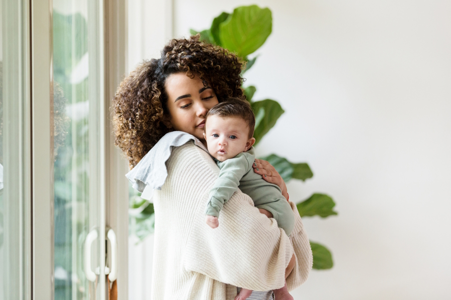 mom holding baby and burp cloth baby essentials you need
