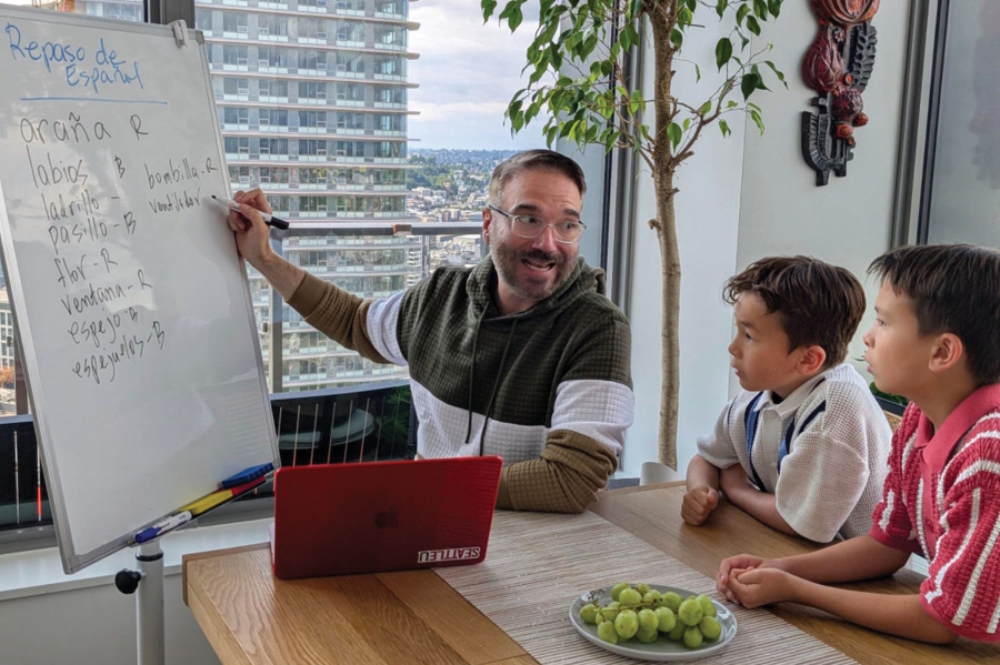 Varona and sons working on Spanish lessons at home