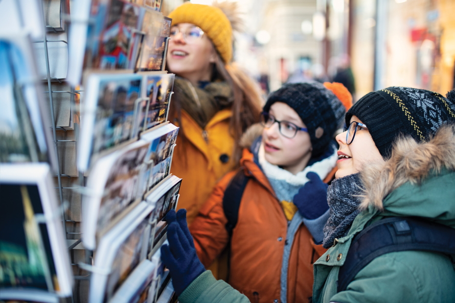 Two kids looking at postcards