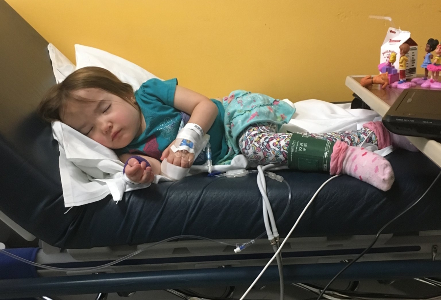 Hailee sleeping in a hospital bed receiving treatment