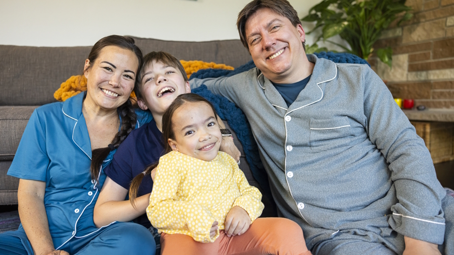 Hailee and her family sitting on the floor together smiling