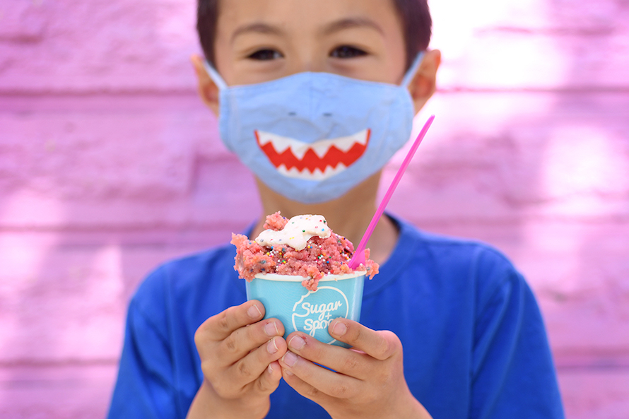 boy in a shark mask holding a cup of edible cookie dough from Sugar + Spoon