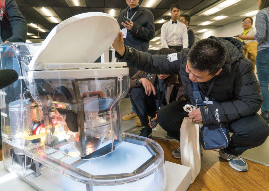 People examining how a toilet works