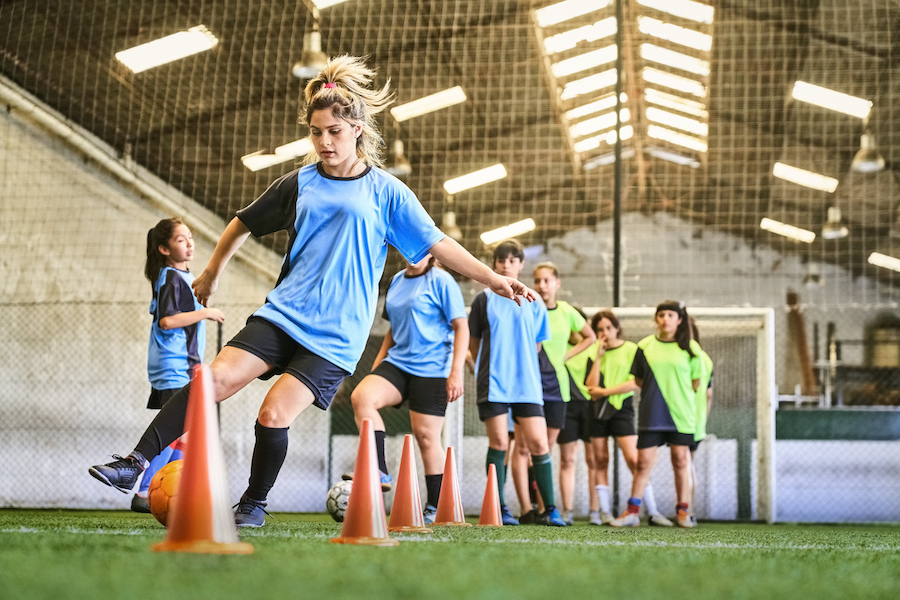 teen girls soccer team practices drills together