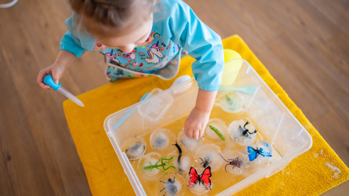 child playing with toys frozen into ice