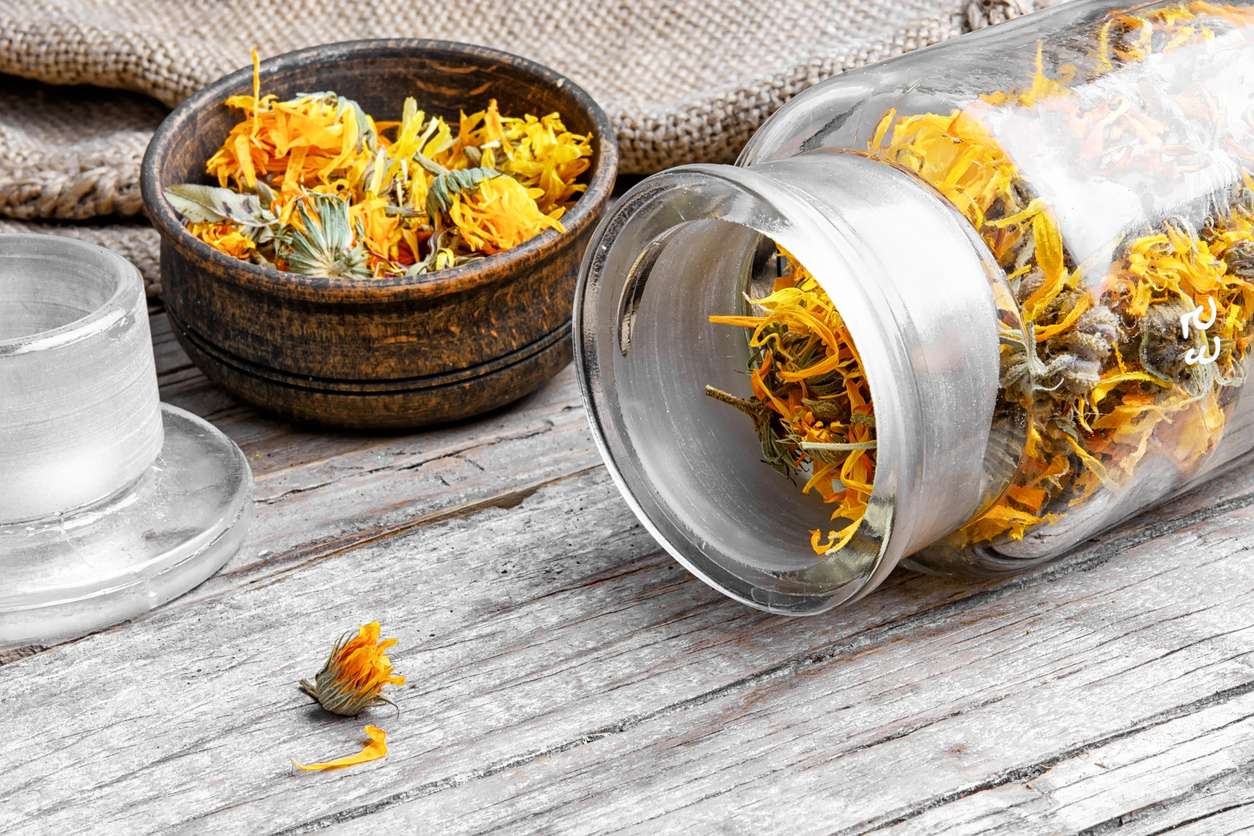 A bottle filled with dried calendula blossoms