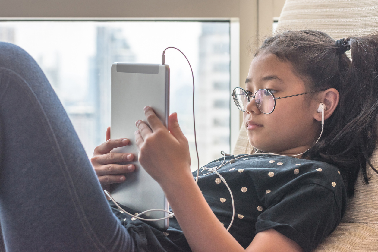 tween girl on a tablet