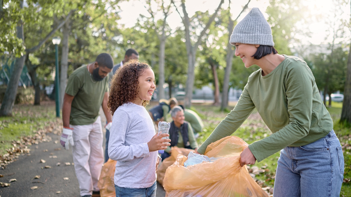 mom and daughter picking up trash as part of a neighborhood clean up project