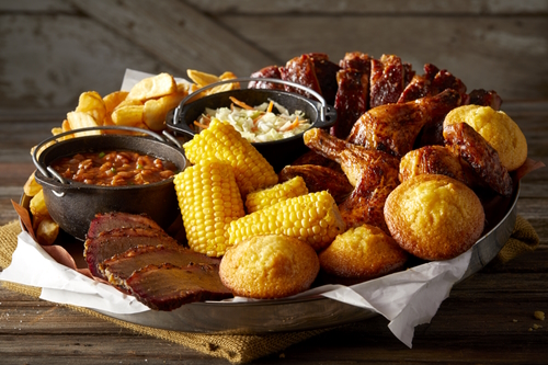 Pile of food from Famous Dave's served on a trash can lid