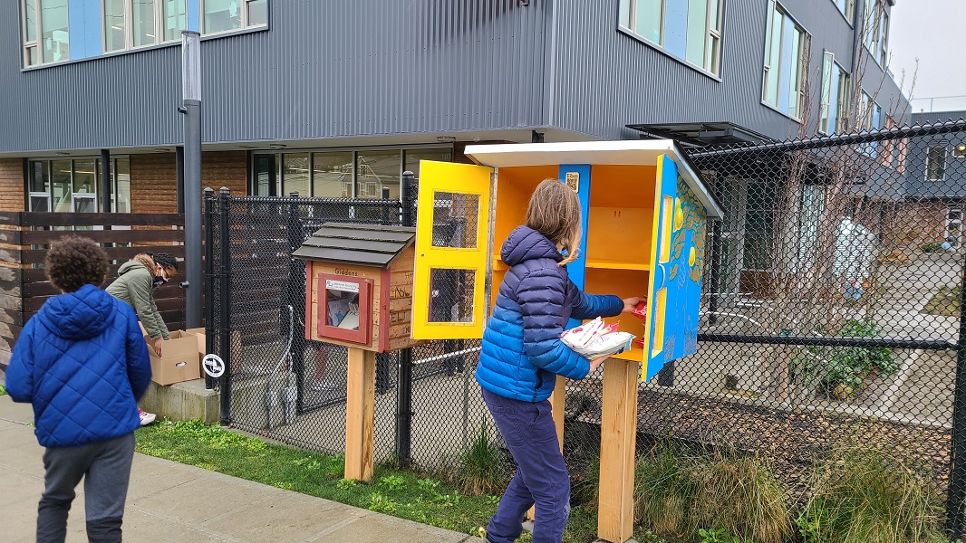 Giddens students stock a Free Little Pantry on the school grounds