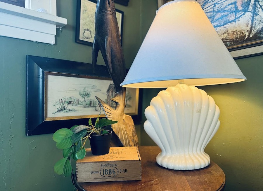 thrifted shell lamp with gallery wall