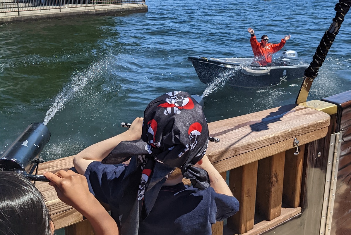 Kids aboard the Family Treasure Cruise blast Cheatin’ Linus with water cannons after he makes off with the treasure