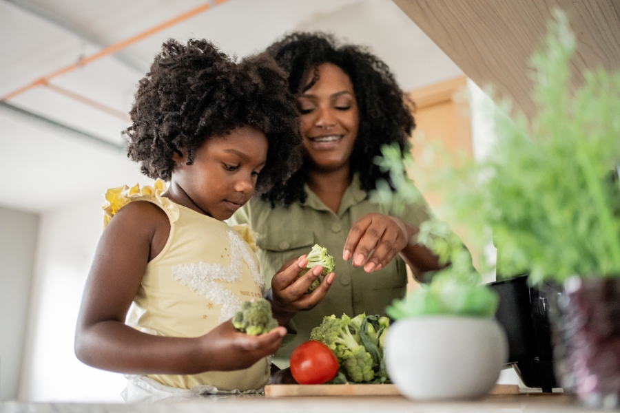 Mom and daughter cooking together 