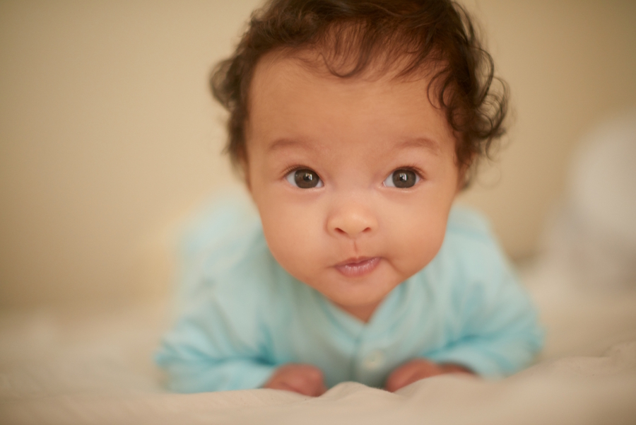 cute baby making a curious half-smile