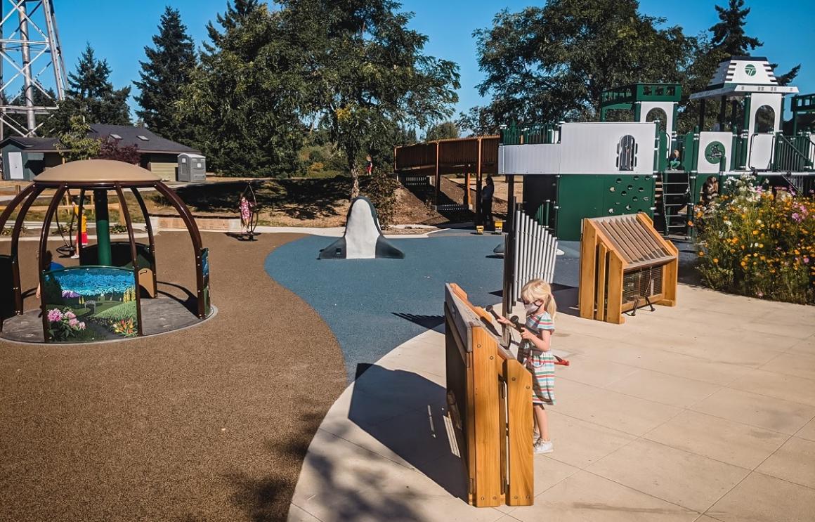 Kids playing with chimes music at new ferry boat playground on Bainbridge Island near Seattle kids and families