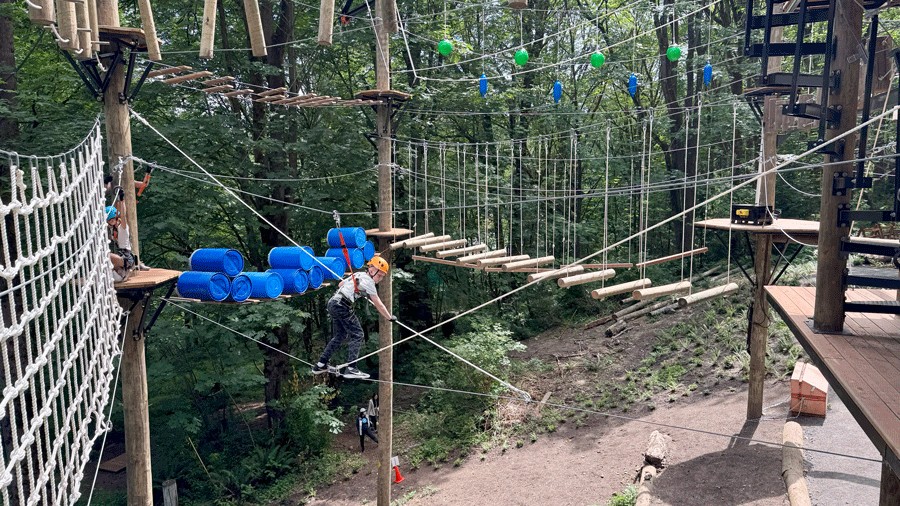 young kid crossing a tightrope at Aerial Park in Bellevue